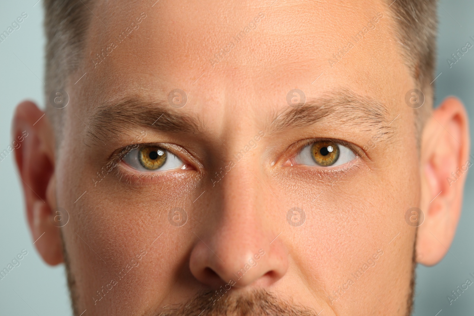 Photo of Closeup view of man with beautiful eyes on blurred background