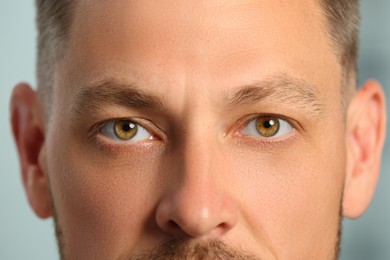 Photo of Closeup view of man with beautiful eyes on blurred background