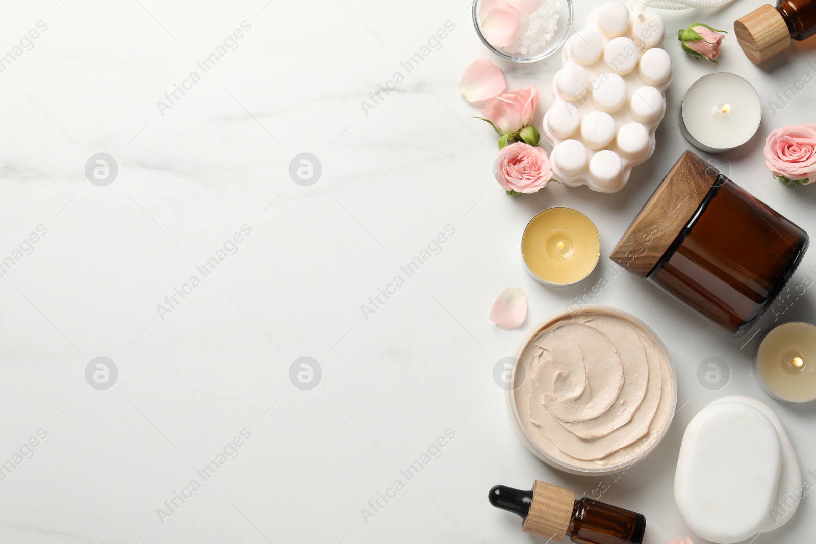 Photo of Flat lay composition with different spa products on white marble table. Space for text