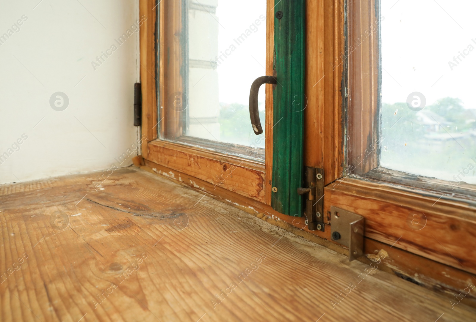 Photo of Old window with wooden sill in room, closeup