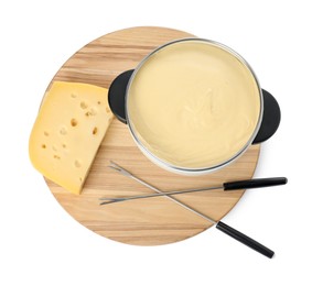 Photo of Fondue with tasty melted cheese, forks and piece isolated on white, top view