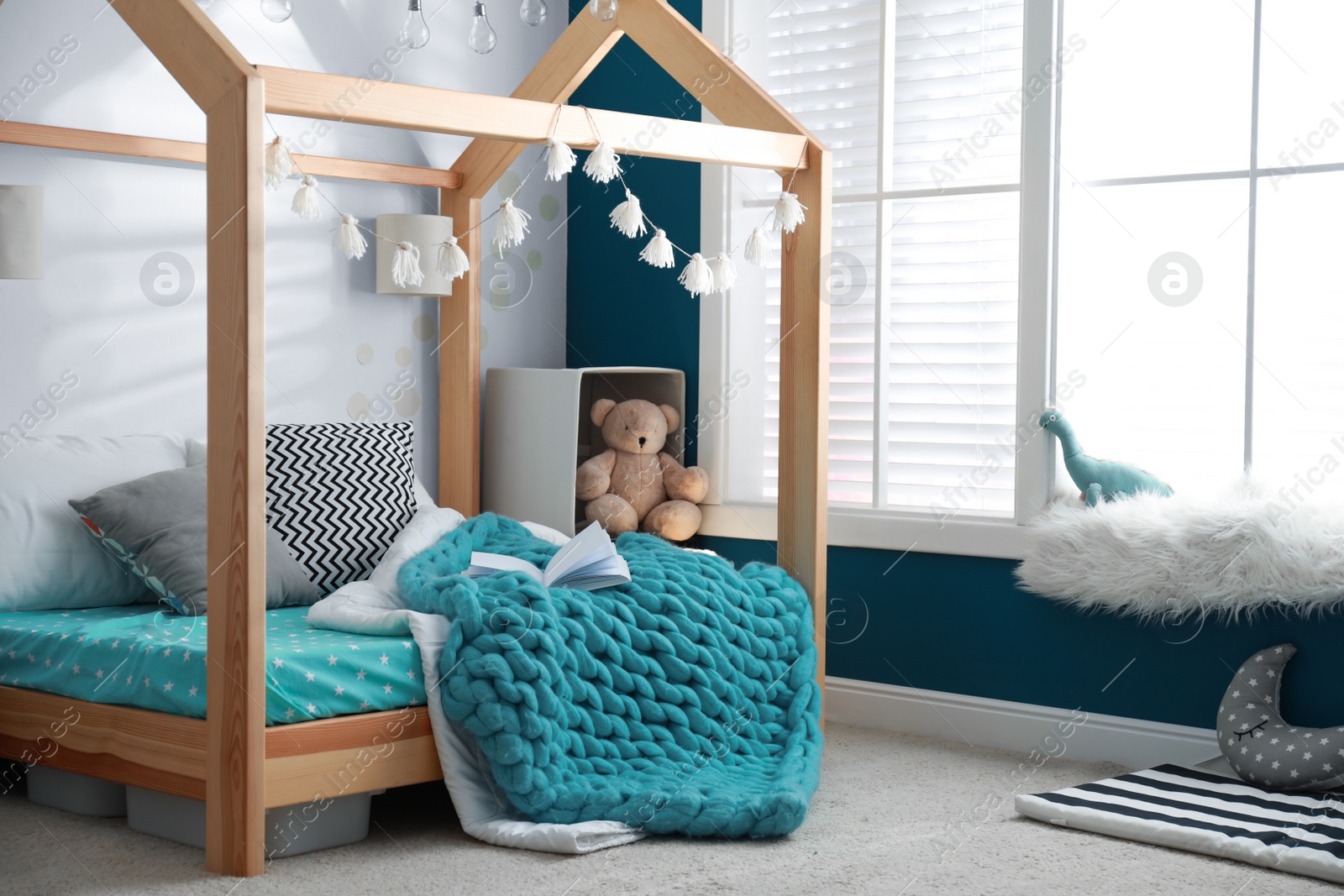 Photo of Cozy child room interior with comfortable bed