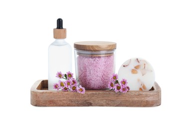 Glass container of pink sea salt, bottle with essential oil, natural soap and beautiful chrysanthemum flowers isolated on white