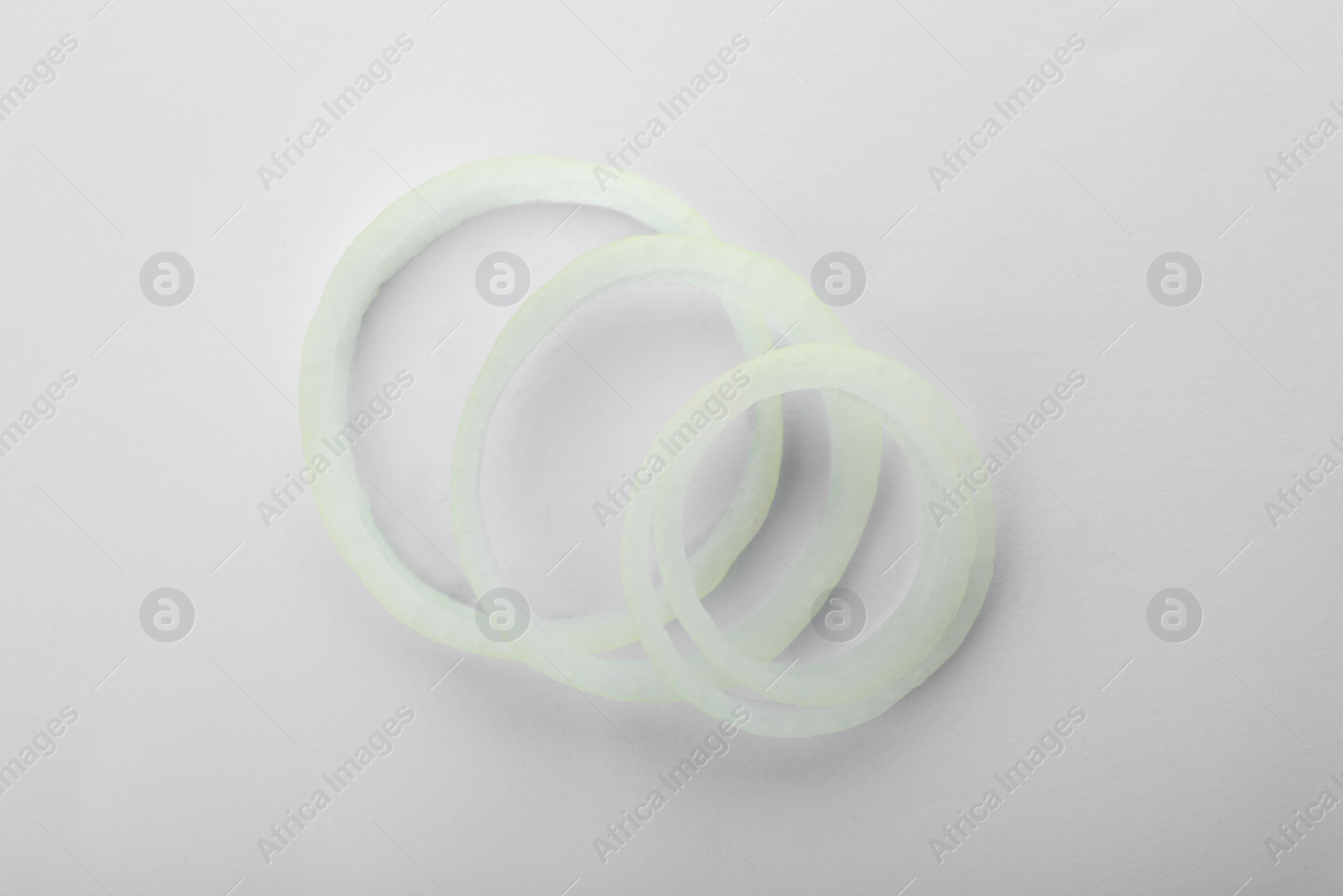 Photo of Fresh onion rings on white background