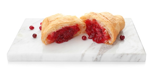 Photo of Tasty croissant with jam on marble board against white background