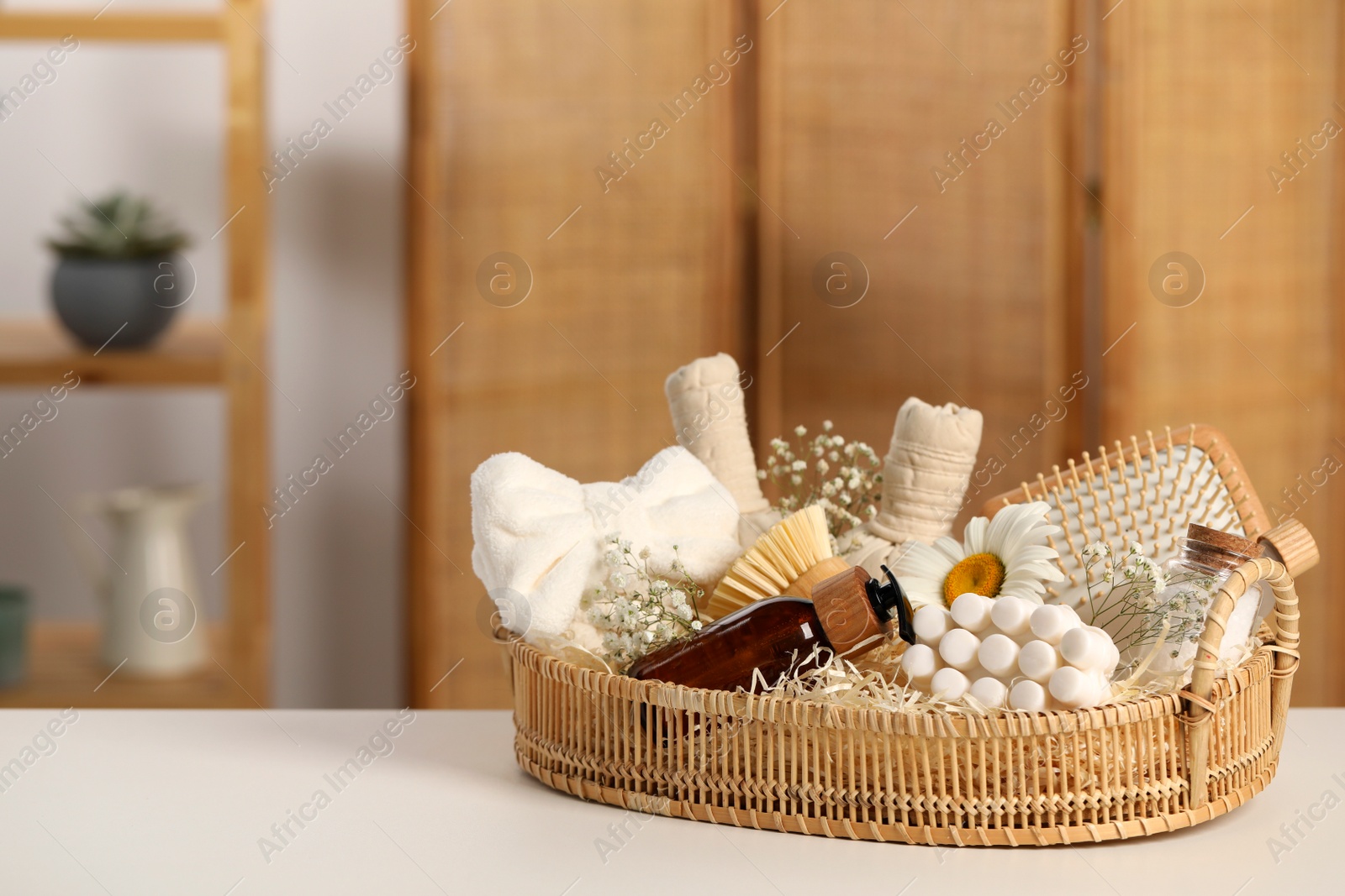 Photo of Spa gift set with different products on white table in bathroom. Space for text