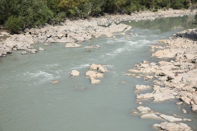 Picturesque view of clear river and rocks on sunny day