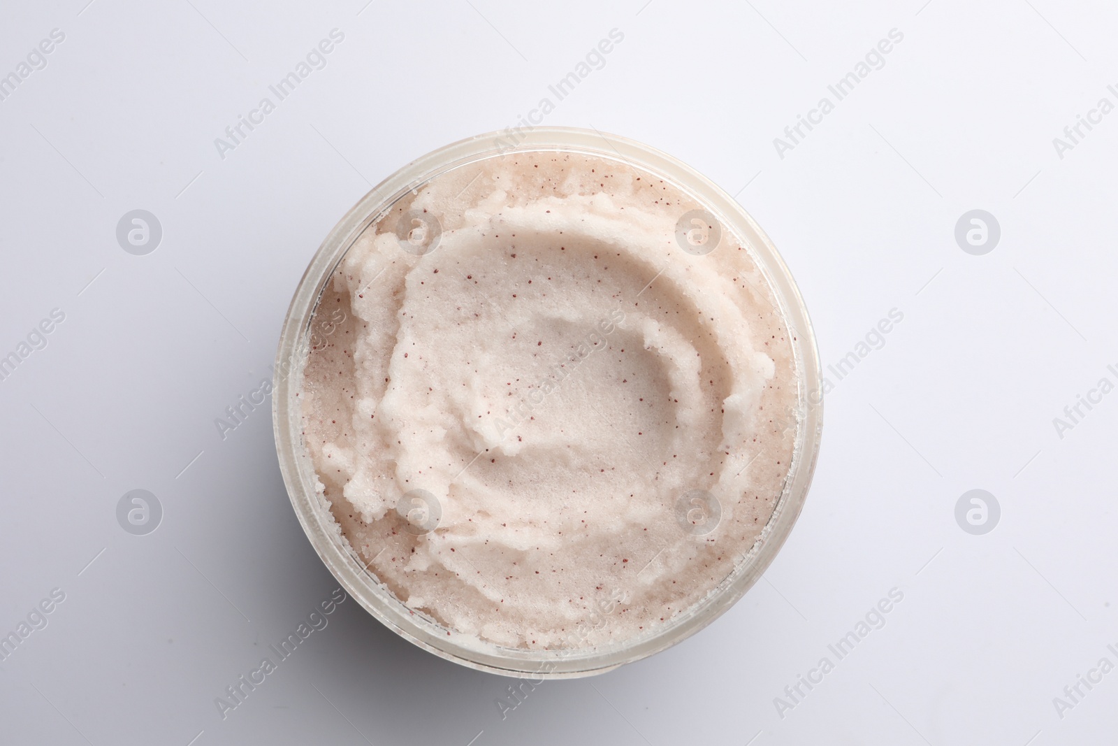 Photo of Jar of scrub on white background, top view