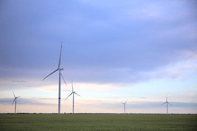 Photo of Beautiful viewfield with wind turbines in evening. Alternative energy source