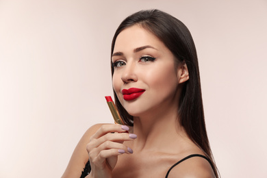 Photo of Beautiful woman with red lipstick on light background