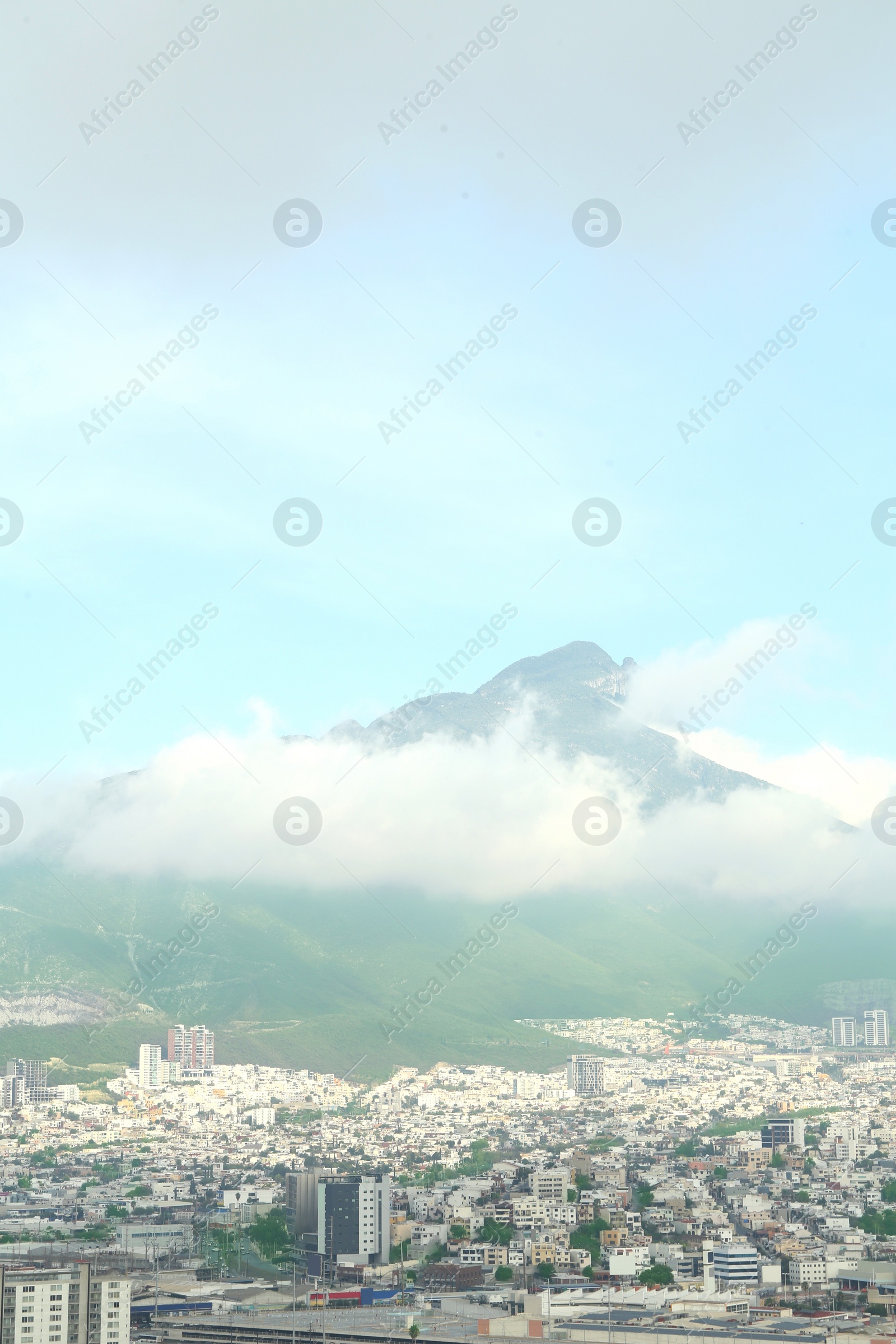 Photo of Picturesque view of cityscape with many buildings near mountain