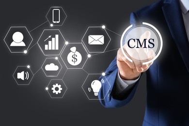 CMS. Man using virtual screen, closeup. Scheme with icons on dark background