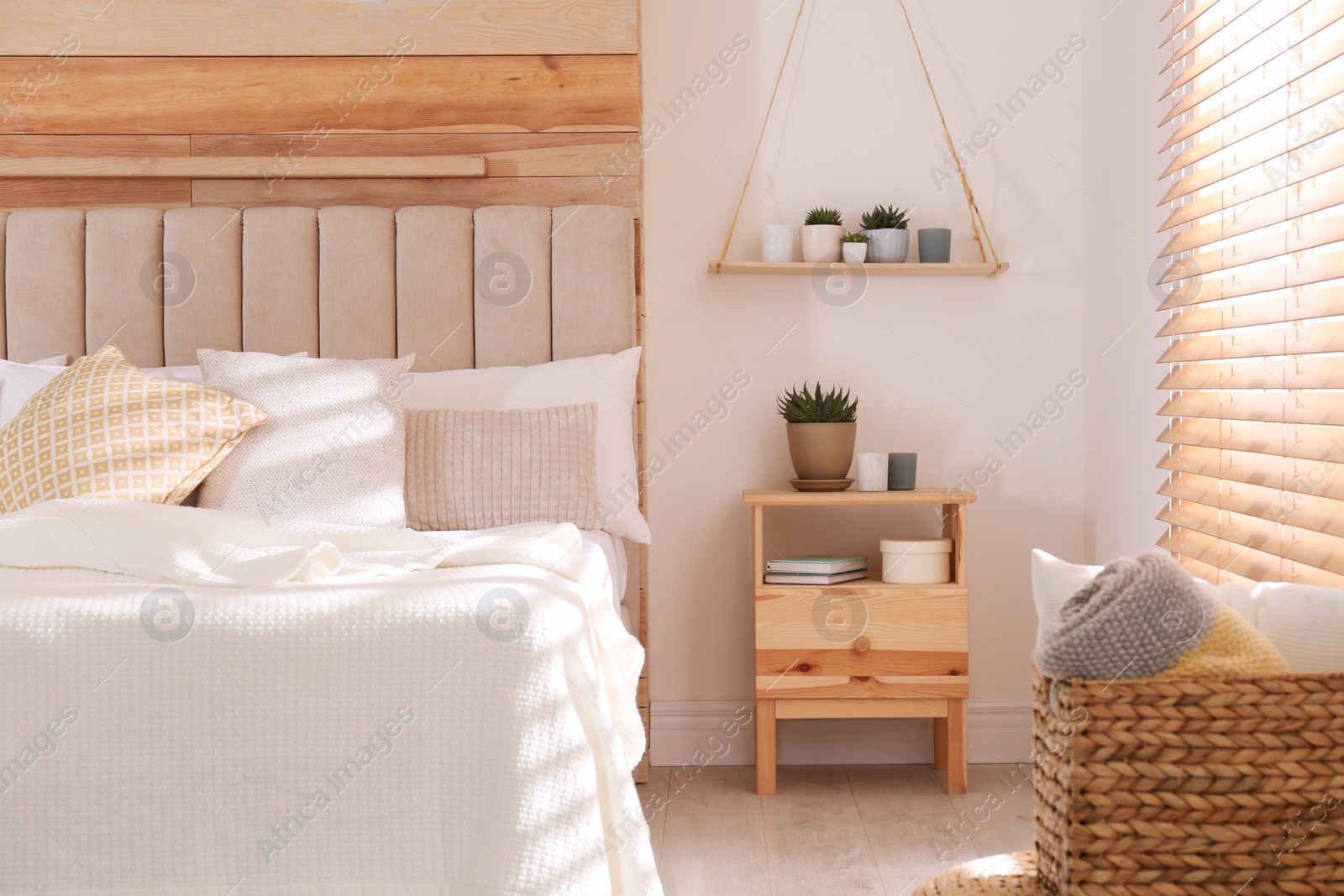 Photo of Comfortable bed with pillows in modern room interior