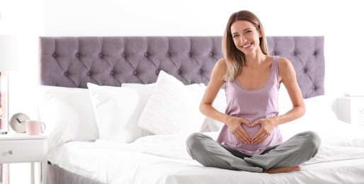 Image of Happy pregnant woman sitting in bed at home, space for text. Banner design