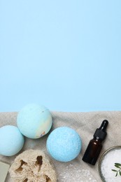 Photo of Flat lay composition with bath bombs on light blue background. Space for text