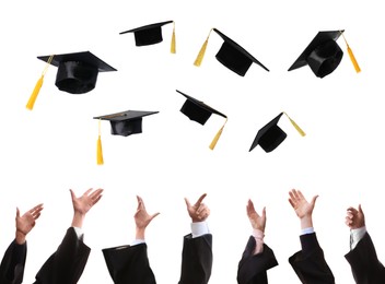 Image of Group of graduates throwing hats against white background, closeup