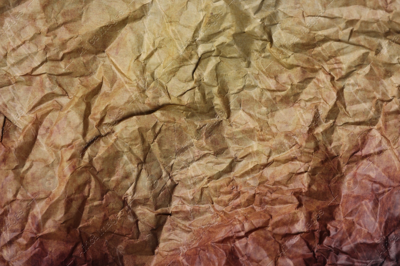 Photo of Texture of crumpled parchment paper as background, top view