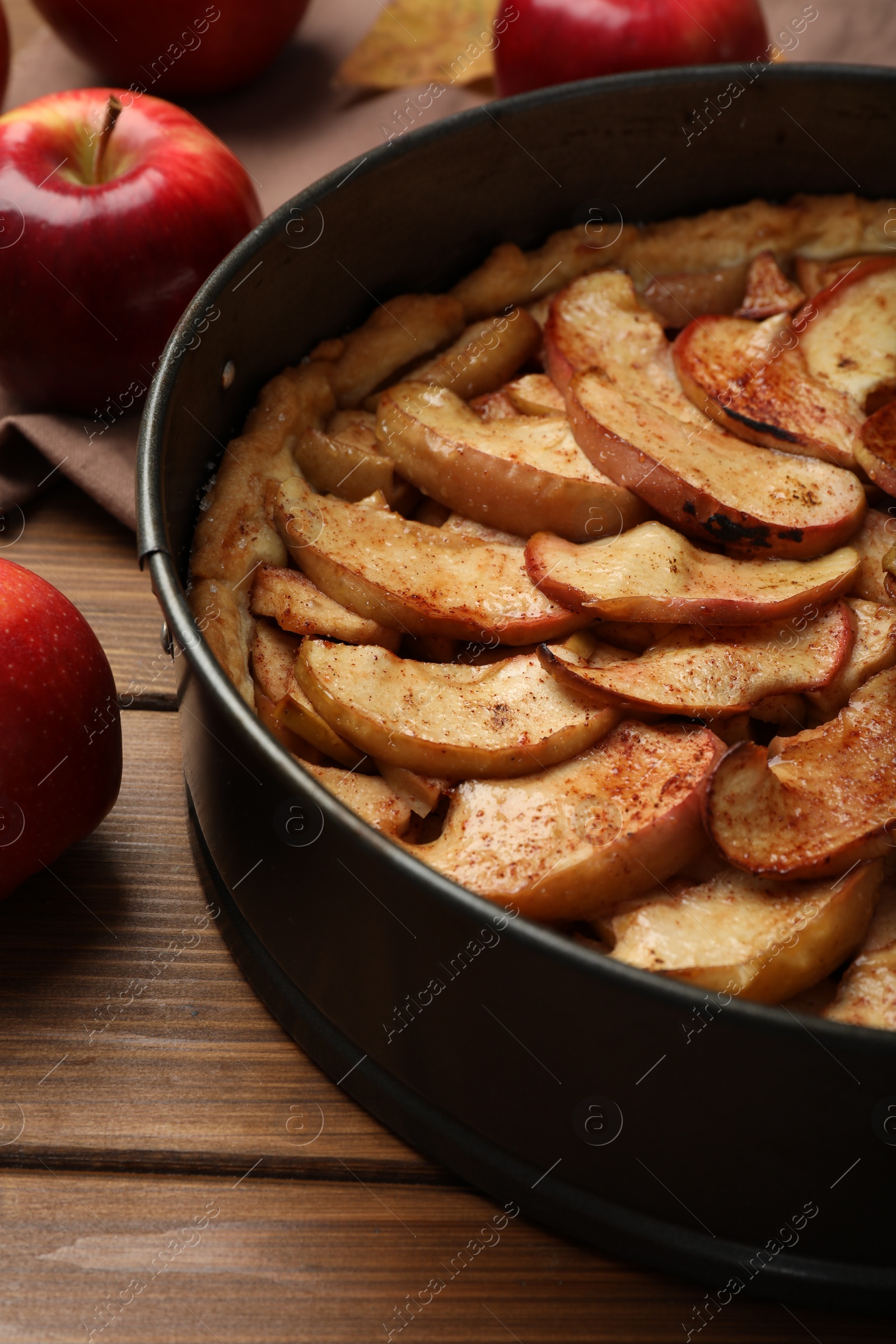 Photo of Delicious apple pie and fresh fruits on wooden table, closeup