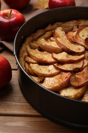 Photo of Delicious apple pie and fresh fruits on wooden table, closeup