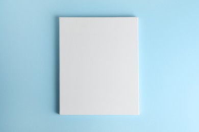 Photo of Blank canvas on light blue background, space for text