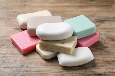 Photo of Many different soap bars on wooden table