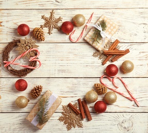 Flat lay composition with Christmas decor and space for text on wooden background. Festive winter design