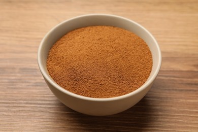 Bowl of chicory powder on wooden table