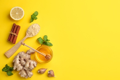 Flat lay composition with different natural antibiotics on yellow background, space for text