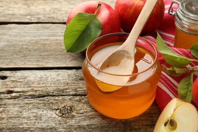 Sweet honey and fresh apples on wooden table, closeup. Space for text