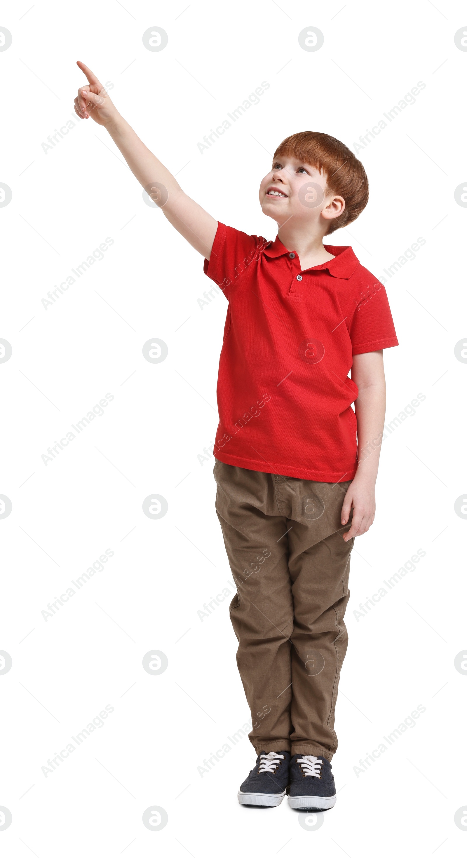 Photo of Little boy pointing at something on white background