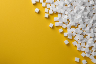Photo of Many styrofoam cubes on yellow background, flat lay. Space for text