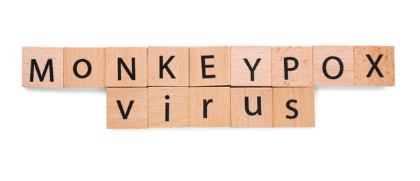 Words Monkeypox Virus made of wooden squares with letters on white background, top view
