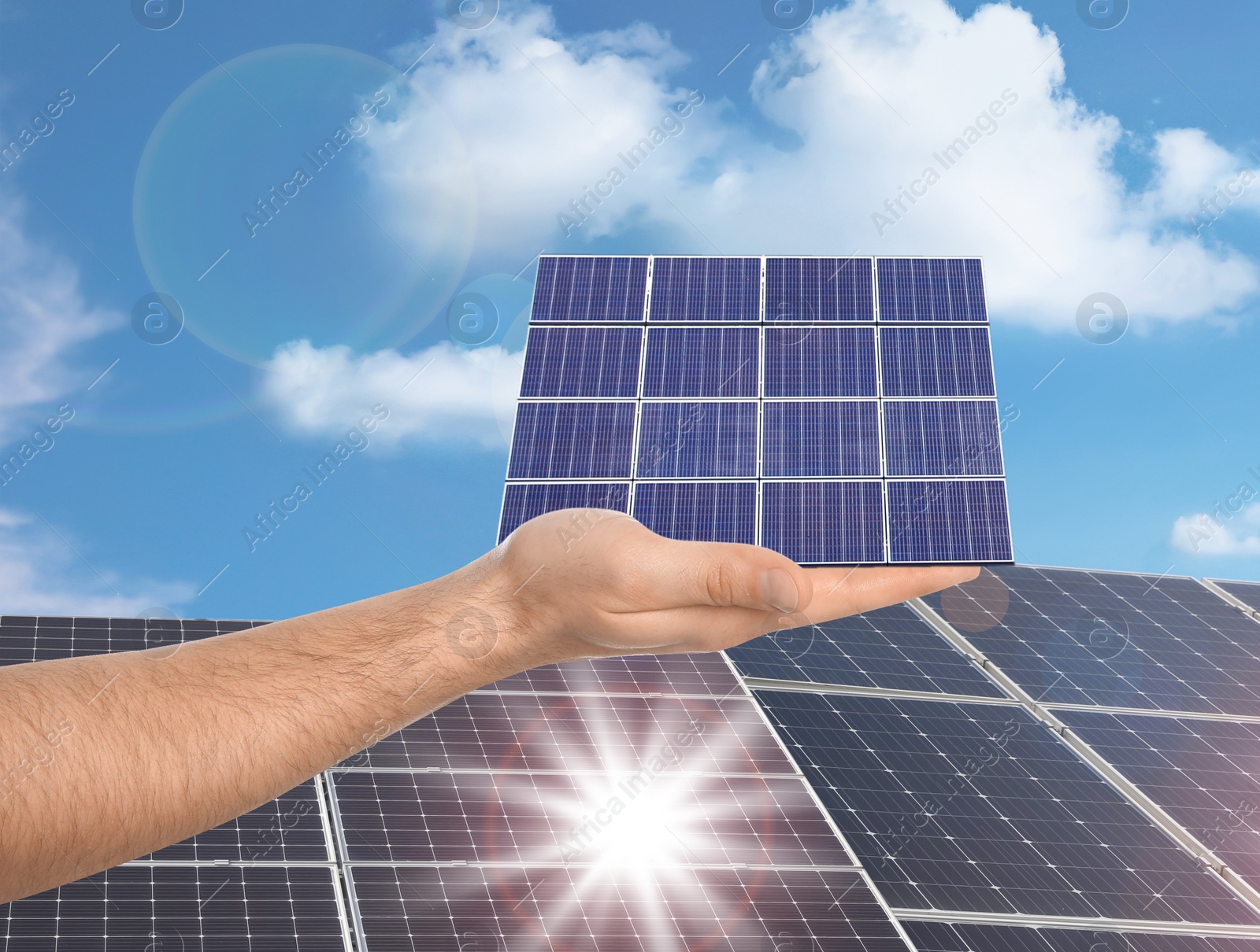 Image of Man demonstrating solar panel outdoors, closeup. Alternative energy source 