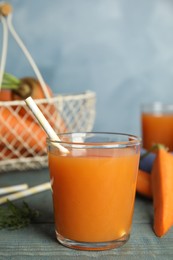 Photo of Glass of freshly made carrot juice on wooden table