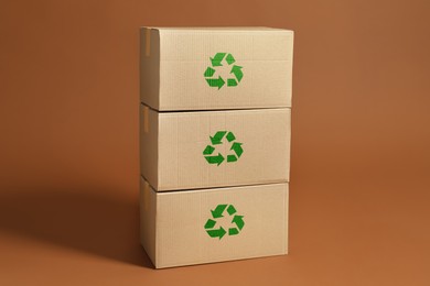 Image of Cardboard boxes with recycle sign stamps on brown background