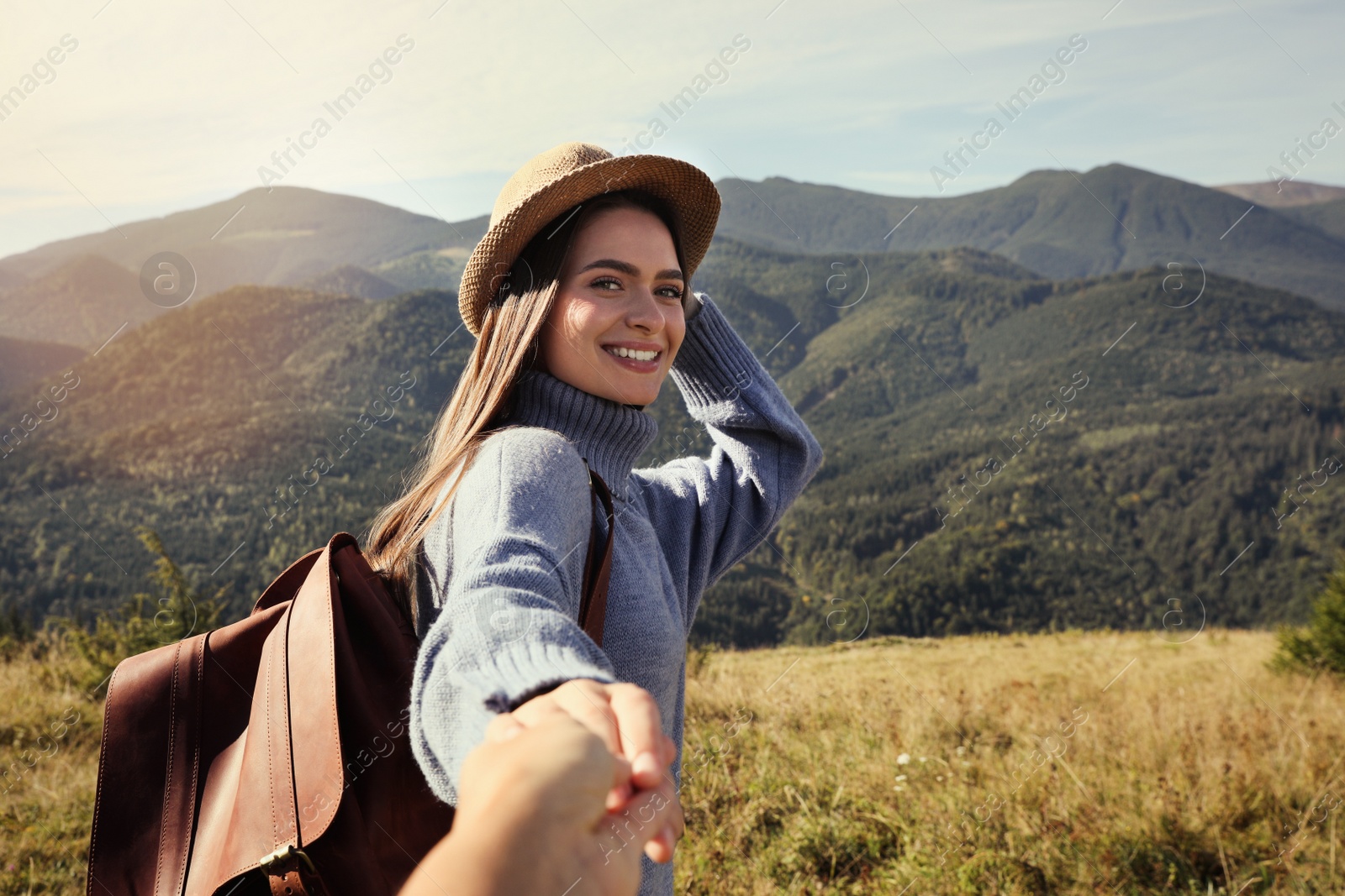 Photo of Young woman with her boyfriend in mountains on sunny day