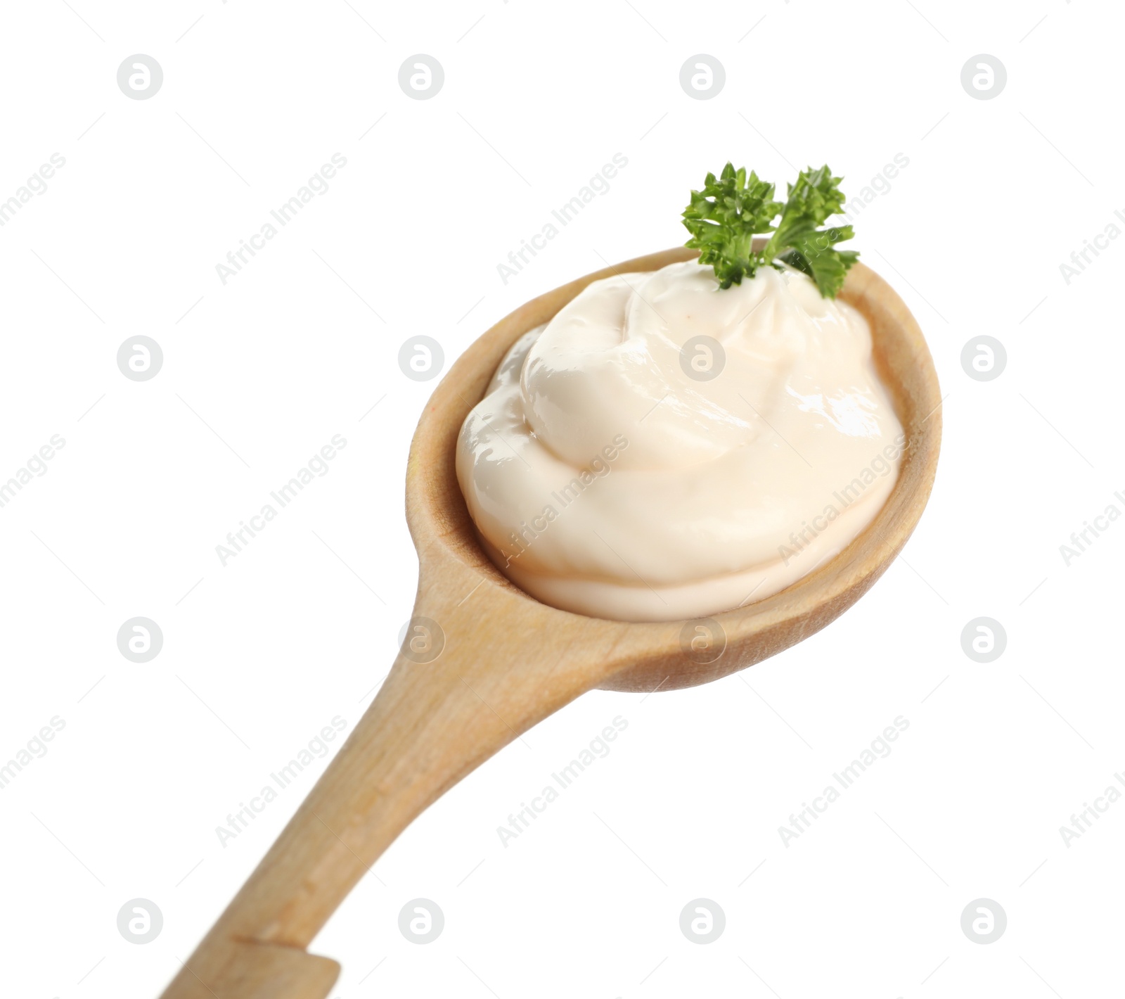 Photo of Wooden spoon with tasty mayonnaise and parsley isolated on white