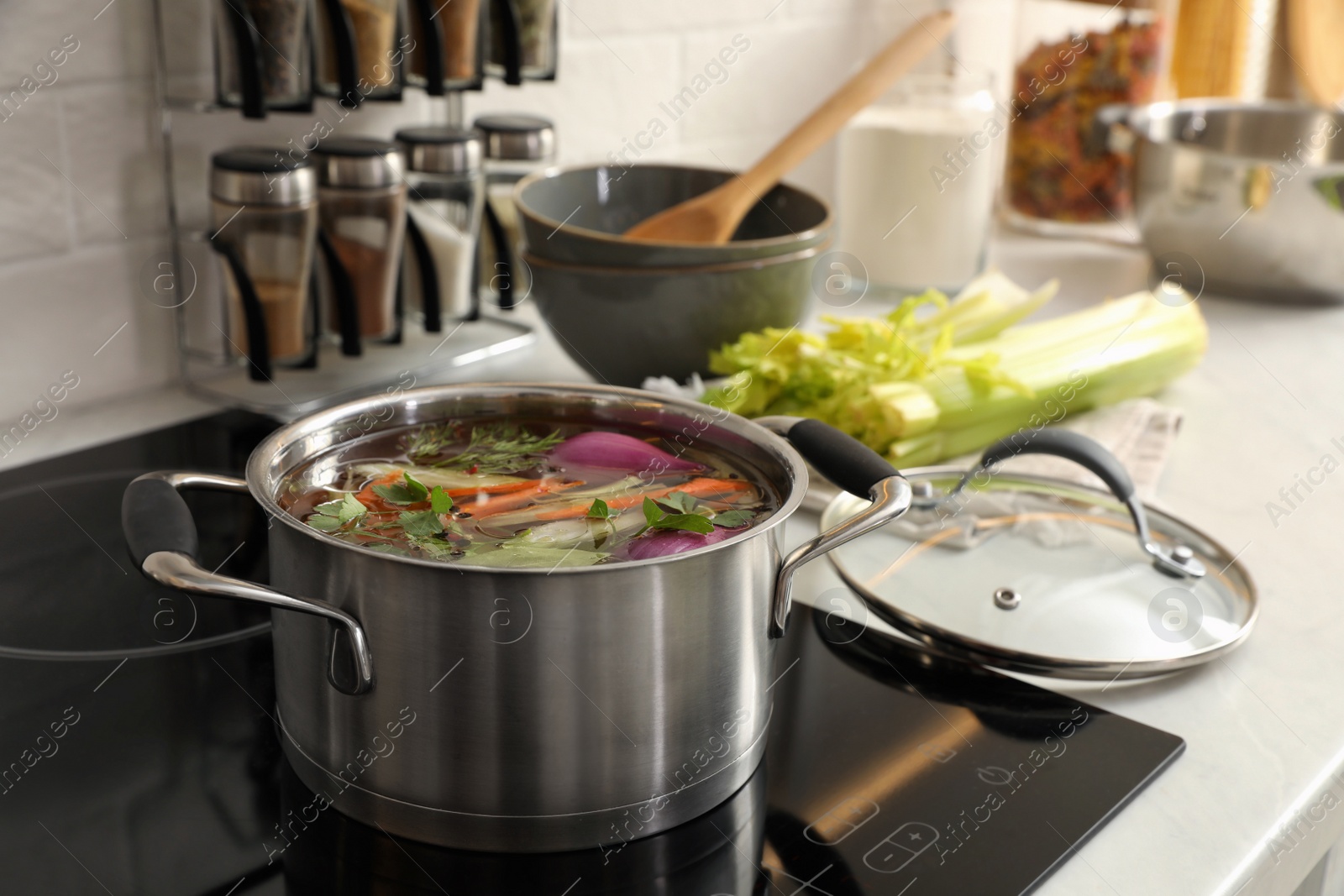 Photo of Pot of delicious vegetable bouillon on stove in kitchen