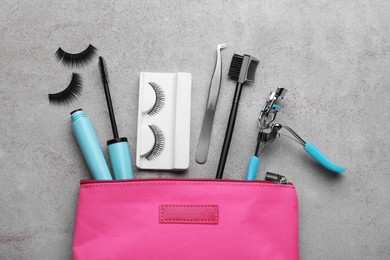Flat lay composition with false eyelashes and tools on light grey background