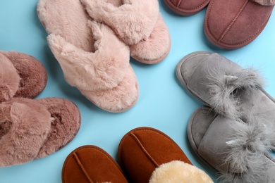 Photo of Many different stylish soft slippers on light blue background, flat lay