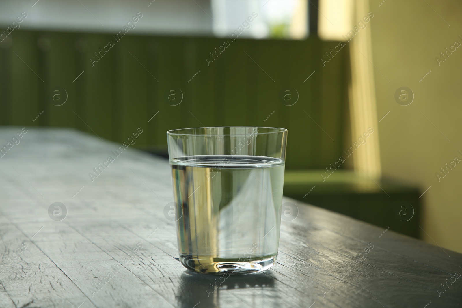 Photo of Glass of fresh water on wooden table indoors