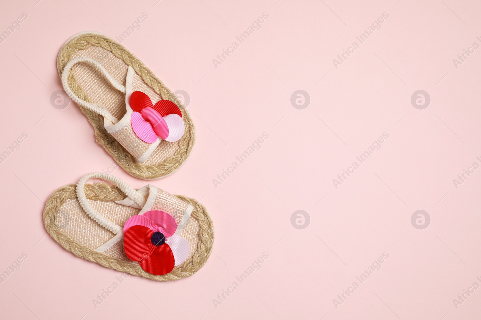 Photo of Cute baby shoes on beige background, flat lay. Space for text