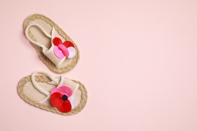 Photo of Cute baby shoes on beige background, flat lay. Space for text