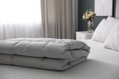 Photo of Soft folded blanket on bed at home