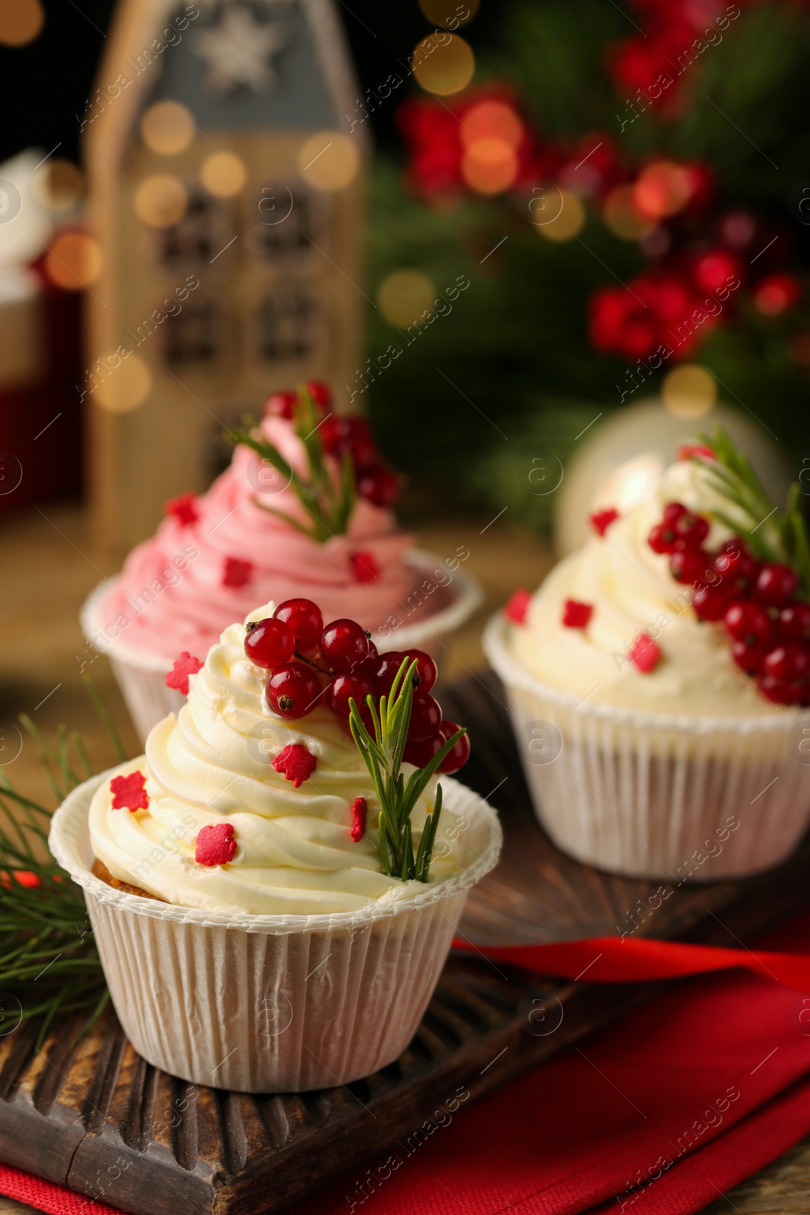 Photo of Delicious cupcakes and Christmas decorations on table