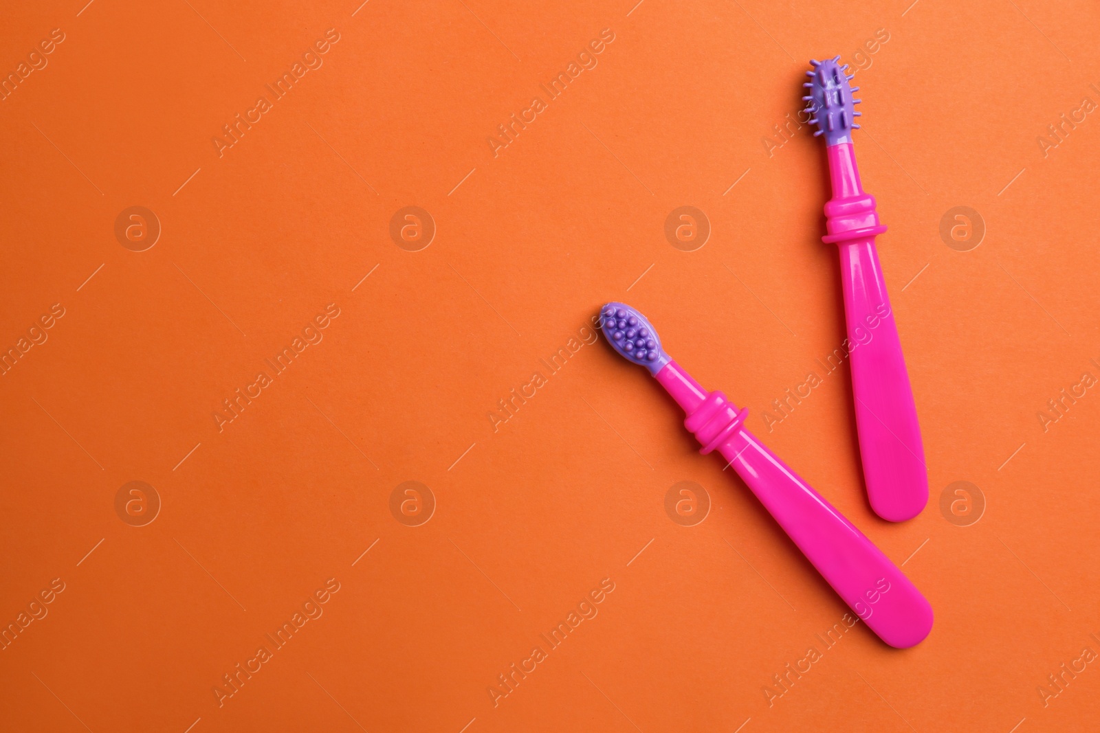 Photo of Manual toothbrushes for children on color background, top view with space for text