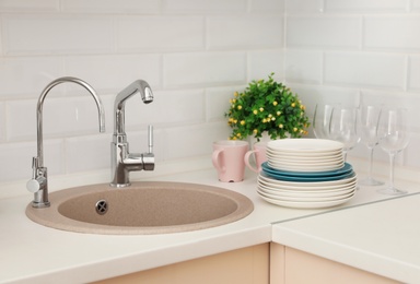 Clean dishes on counter near kitchen sink indoors