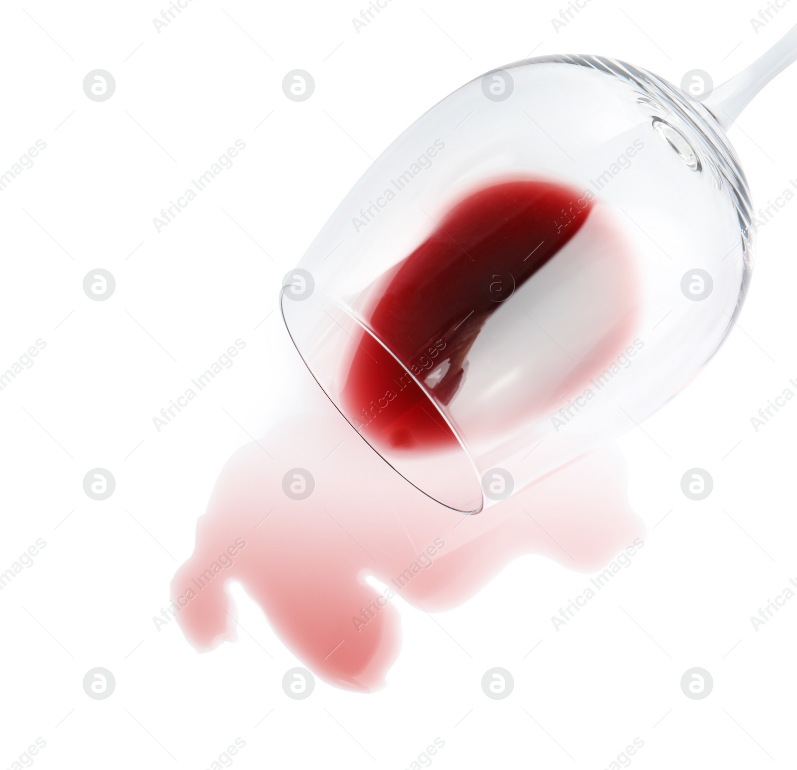 Photo of Transparent glass and spilled exquisite red wine on white background, top view