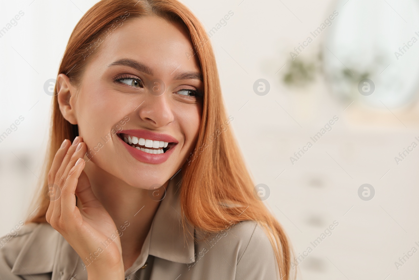 Photo of Portrait of beautiful smiling young woman. Happy lady with red hair indoors. Space for text