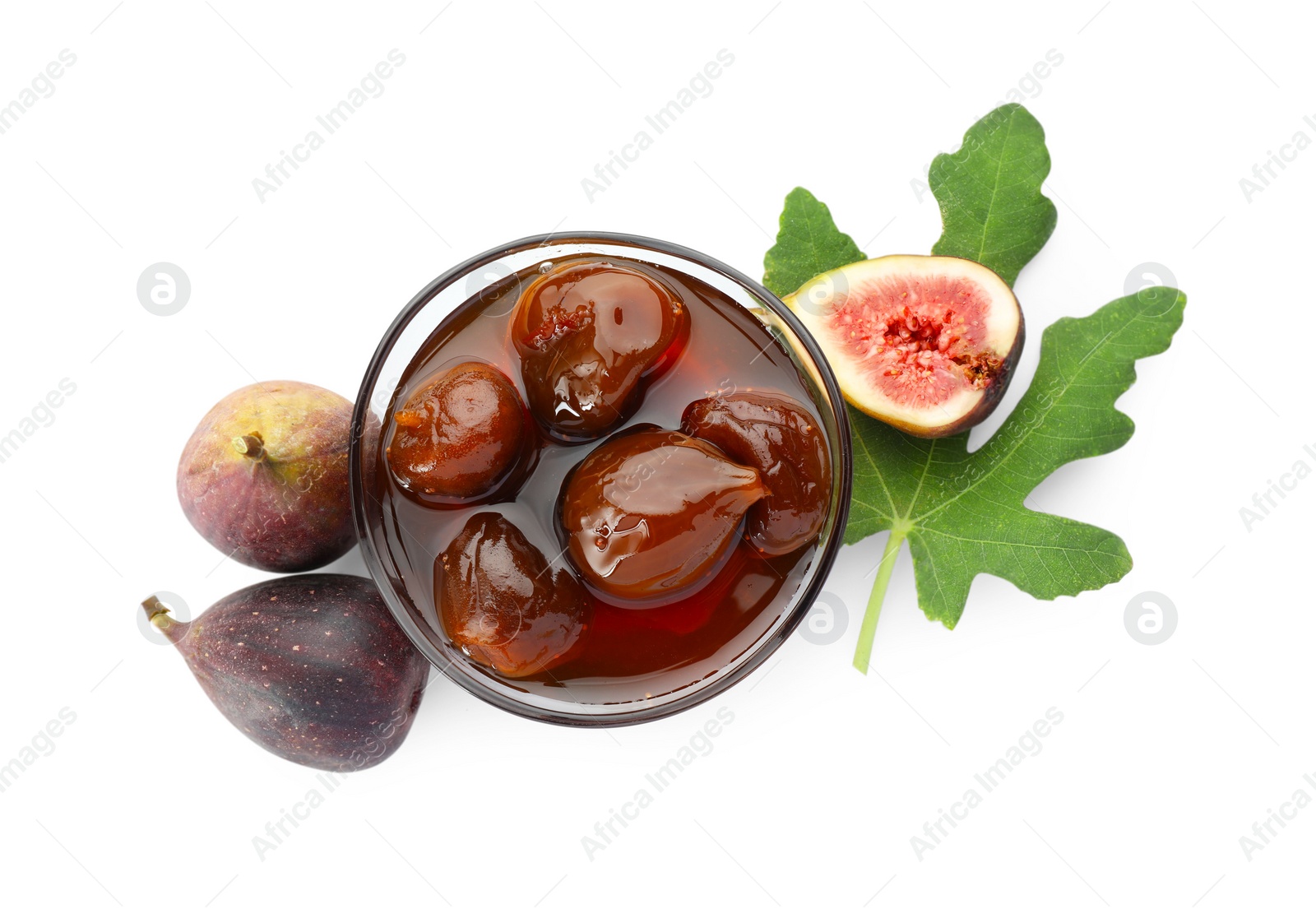 Photo of Bowl of tasty sweet jam, fresh figs and green leaf isolated on white, top view